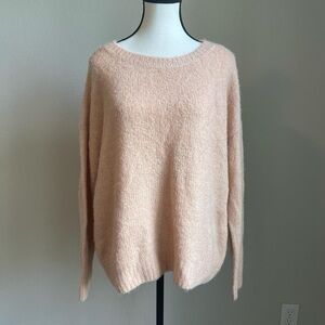 Soft and cozy pink sweater with a round neckline and long sleeves
